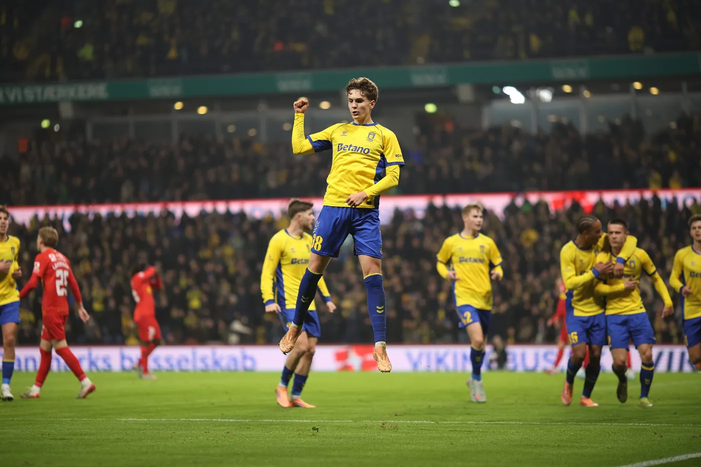 Brøndby players contesting the ball in front of a packed home end at Brøndby Stadion in November 2025